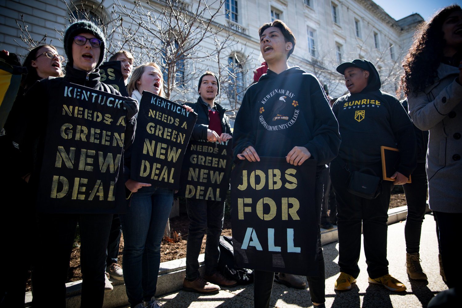 Protesters with placards with slogans including 'jobs for all', Kentucky needs a green new deal',