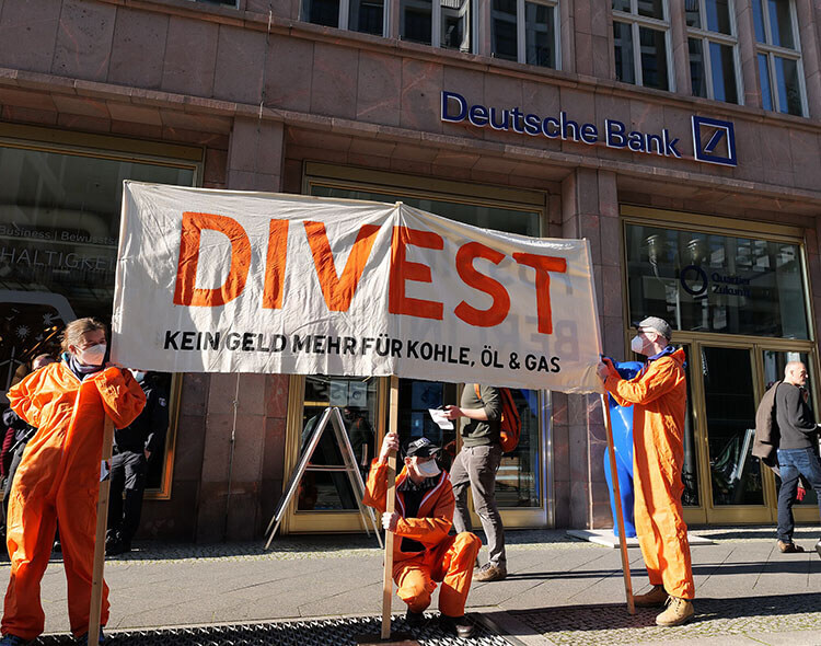 Divest campaigners outside a Deutsche Bank branch.