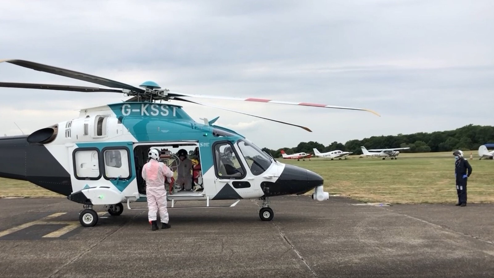 Image of training APU load - crew in PPE and pilots as safe distance