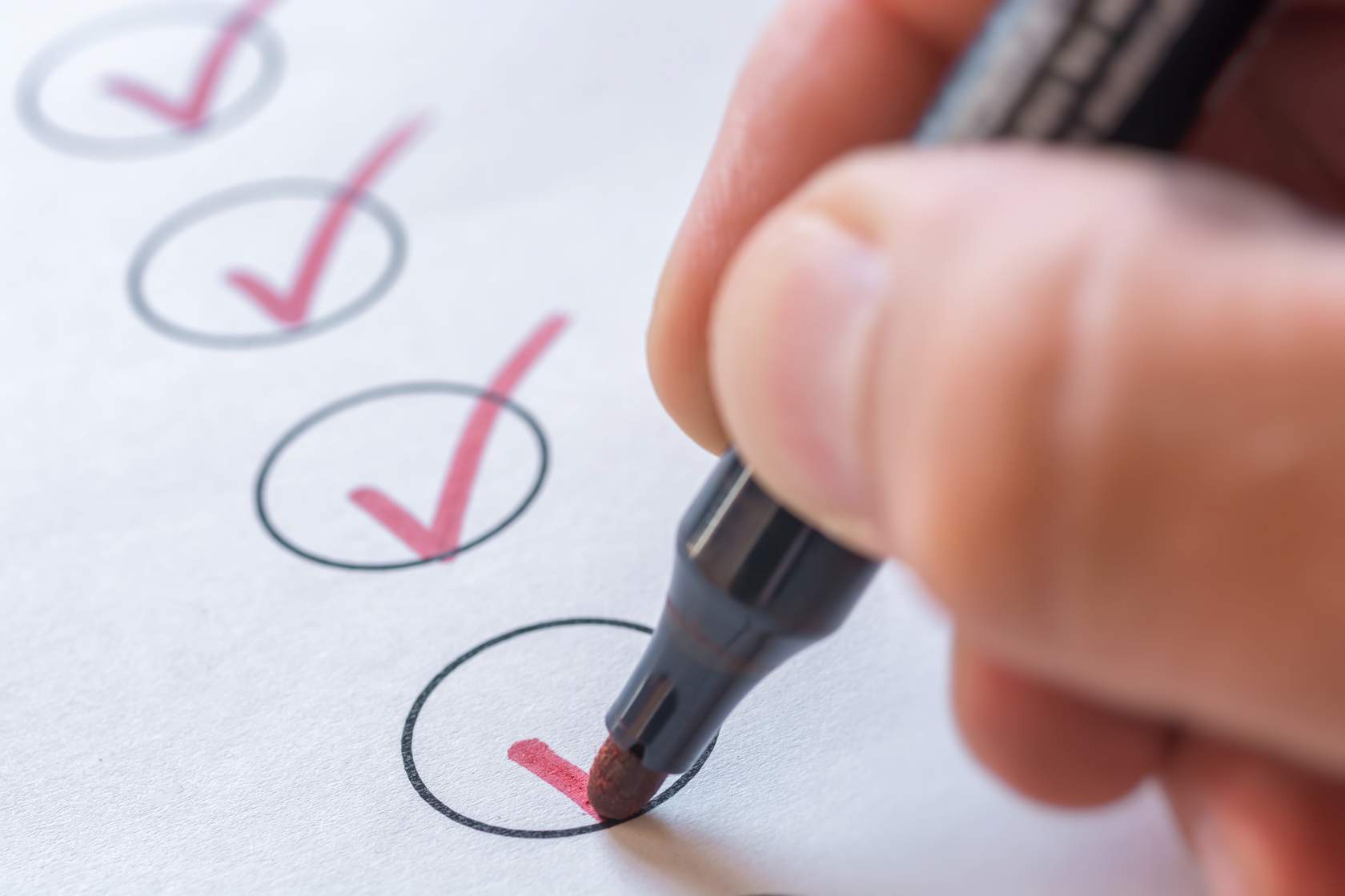 Picture of hand ticking a paper