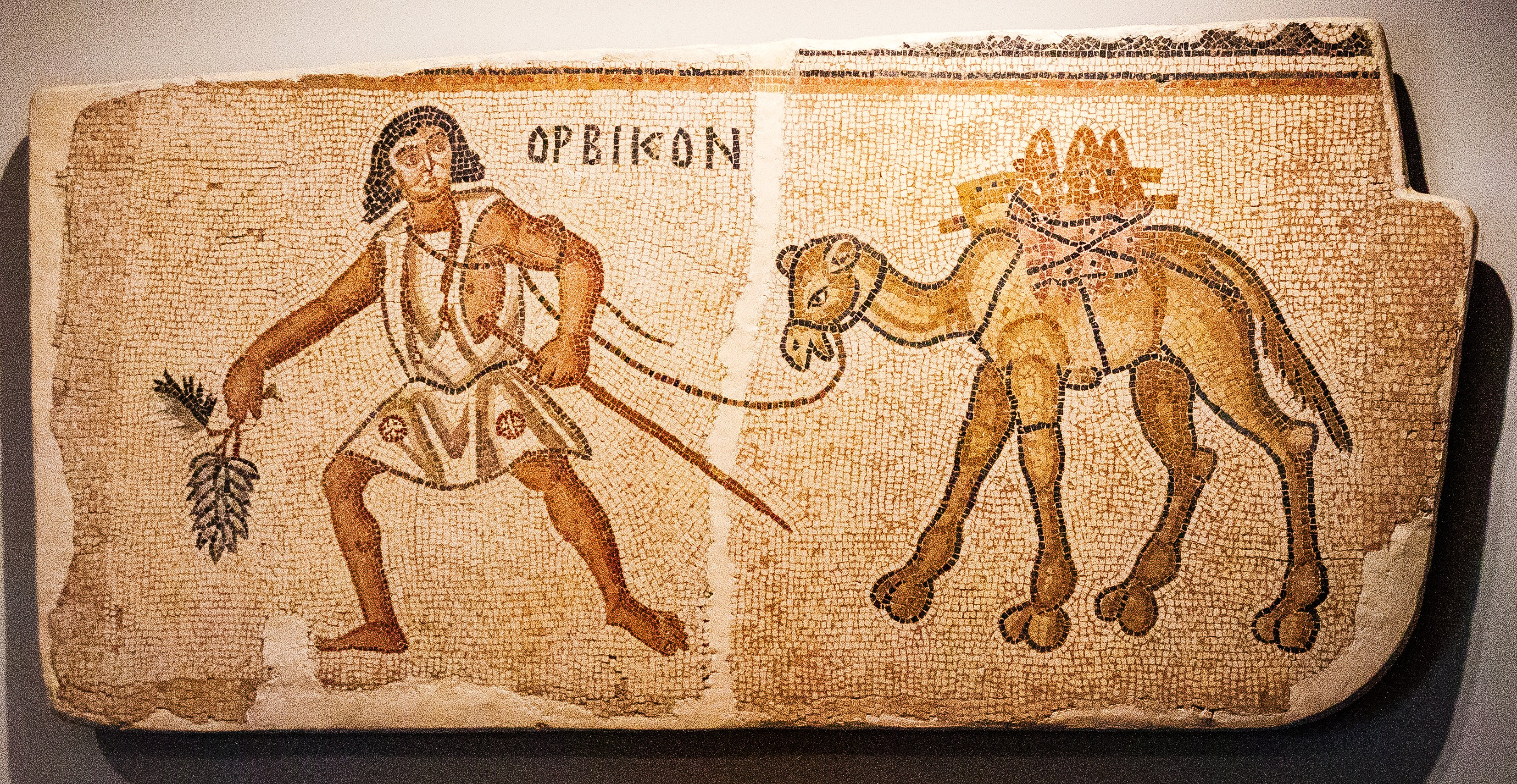 Mosaic of a man and a camel transporting amphorae