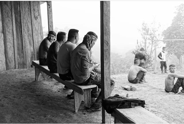Members of FARC watch a game of afternoon football at the Icononzo camp. © Chiara Mizzoni Members of FARC watch a game of football