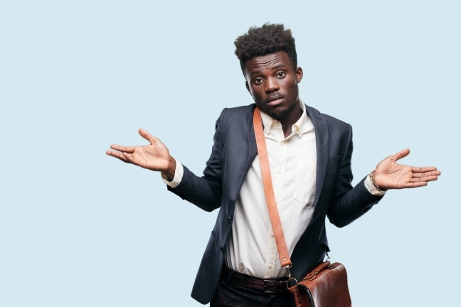 Young man with arms held in questioning pose