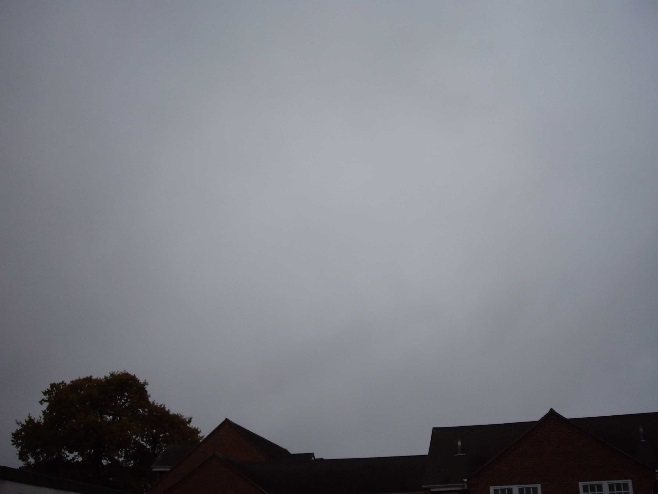 Very faint wispy white clouds against a grey sky