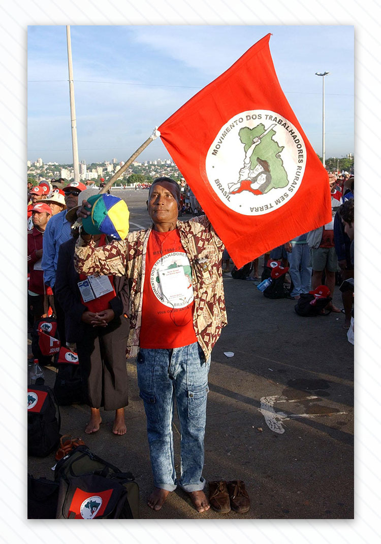Man with Landless Workers’ Movement flag.