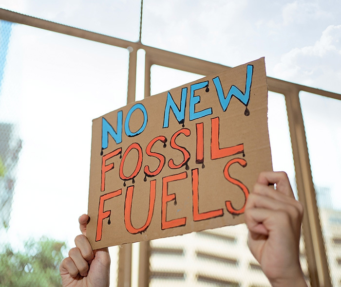 Protest sign saying "No new fossil fuels".
