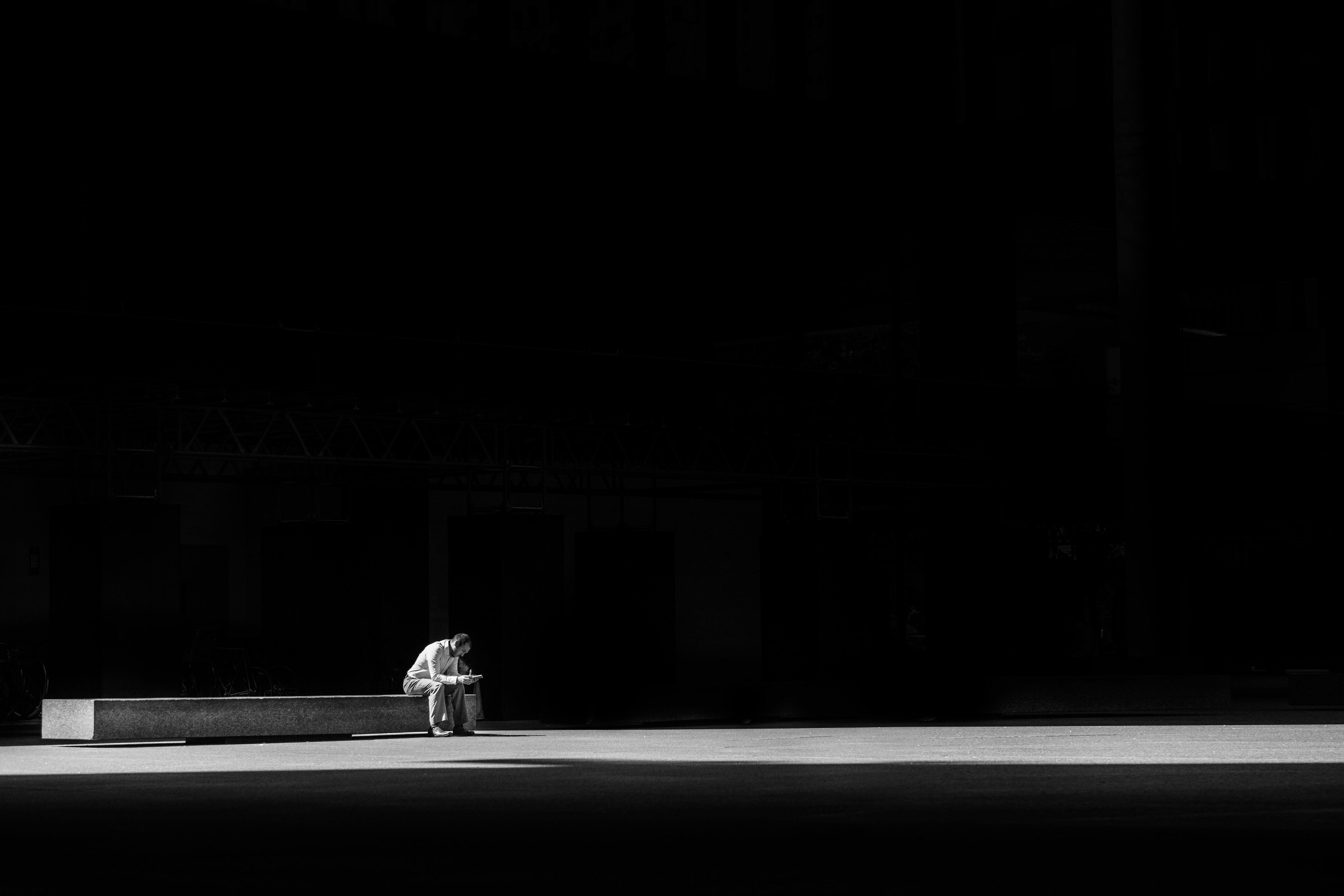 Man sitting on a concrete bench.