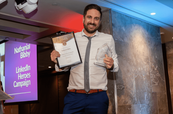 Nathanial Bibby holding awards