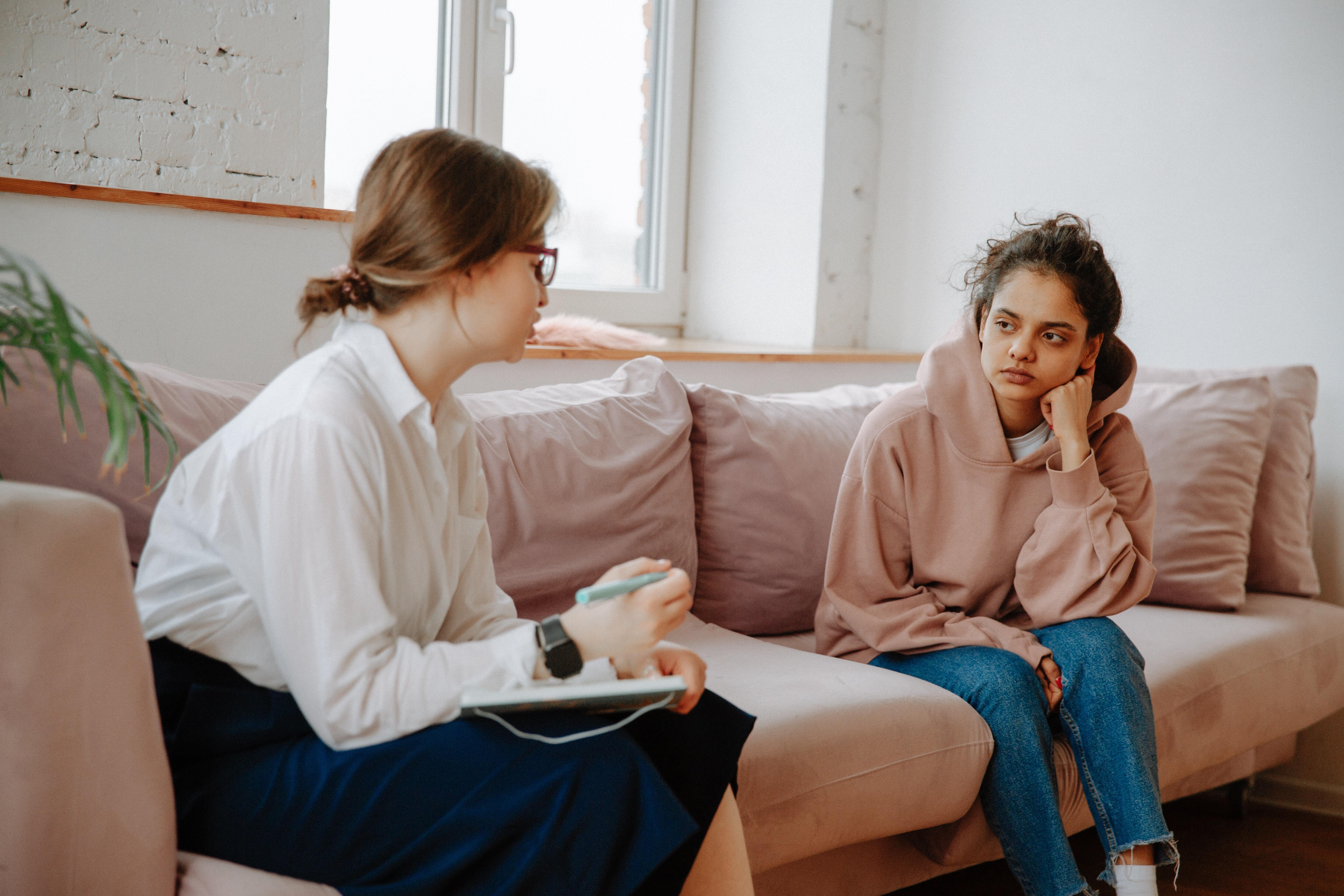 A person talking to a therapist on a couch.