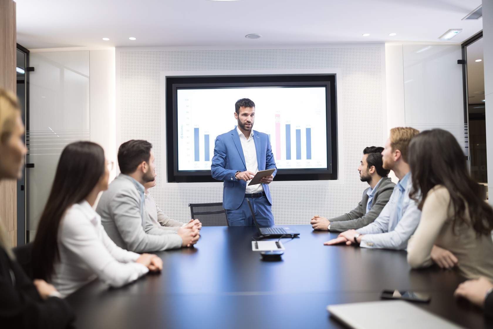 Professional meeting being lead by a men in a suit