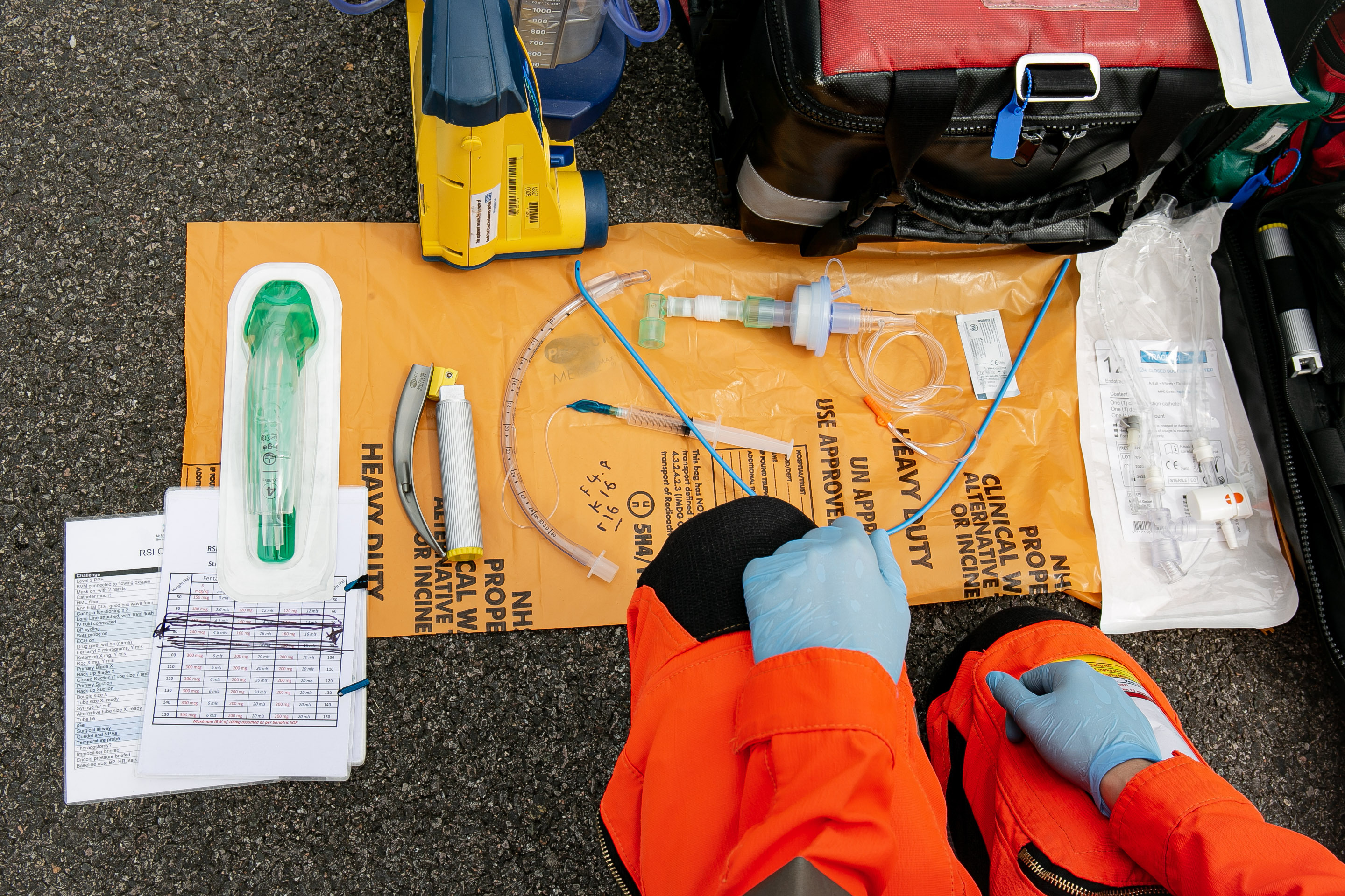 Immediately-required airway equipment laid out on clean plastic sheet