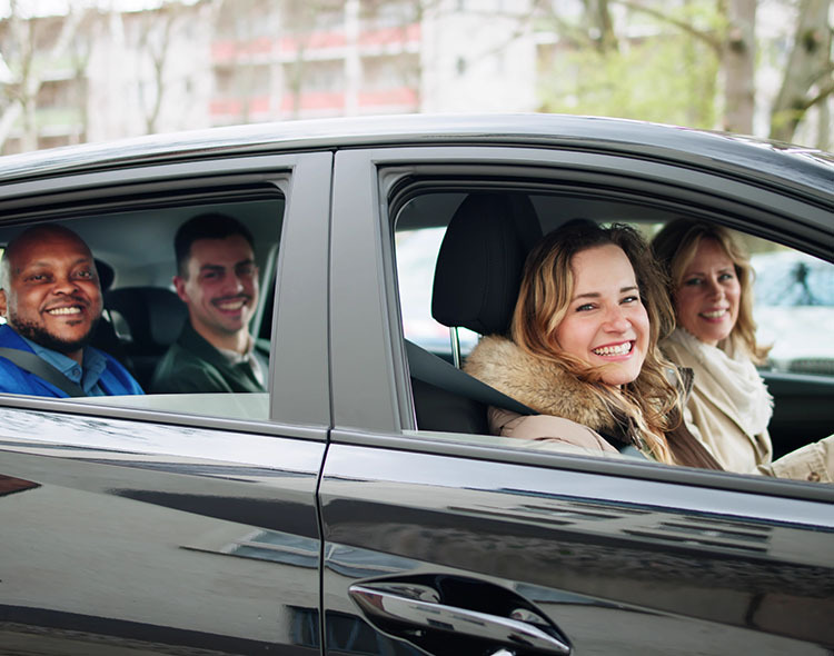 Four adults carpooling together.