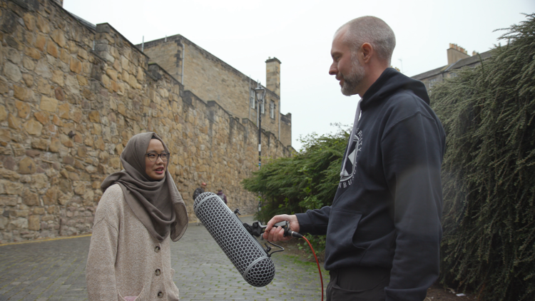 An example of someone being interviewed on the street for a VOX pop video.