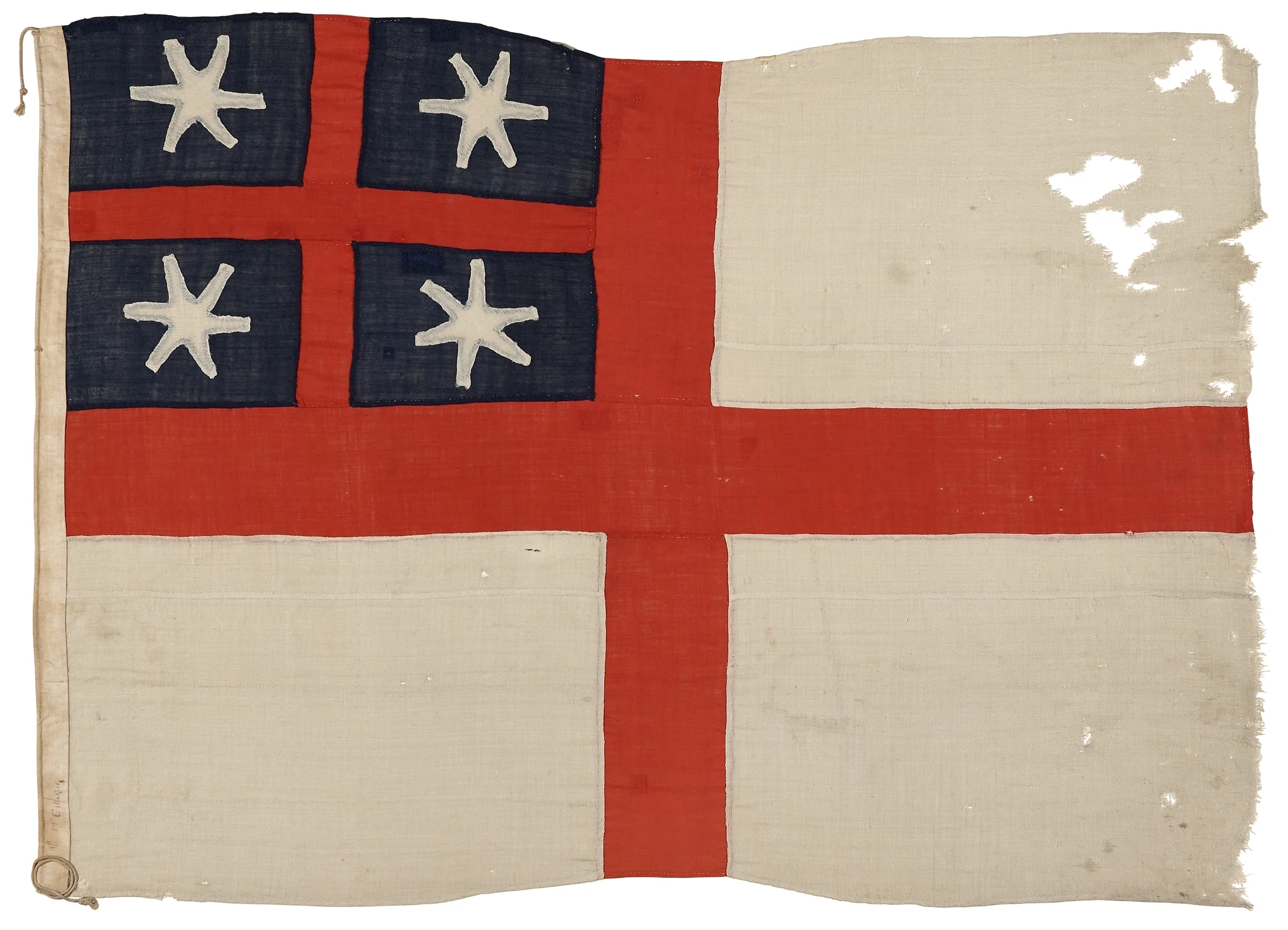 An aged flag, a white base with a large red cross on it. The top left quadrant is divide further by another red cross, inside each is a white star on a blue background. The flag has some worn holes in the top right.