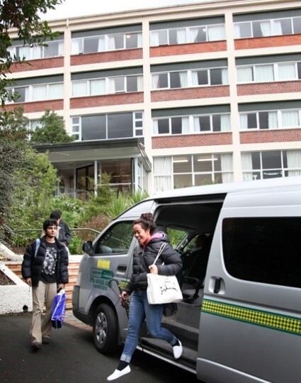 Woman leaving a shuttle bus