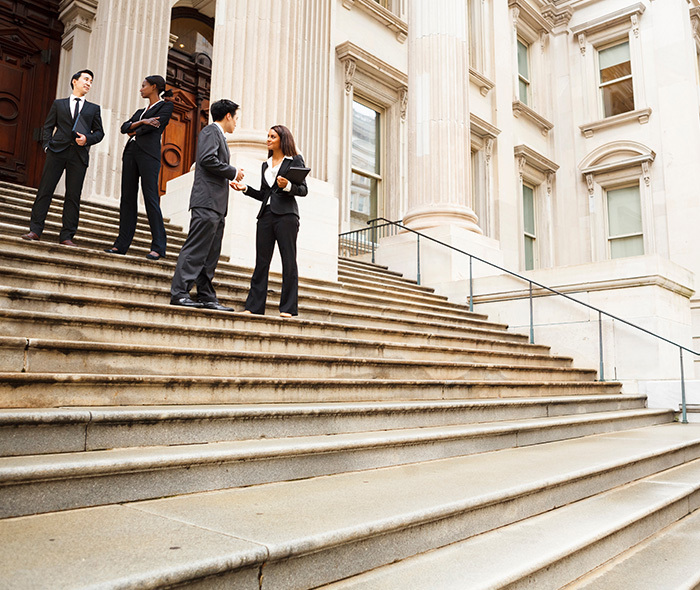 Workers on steps of a government building.