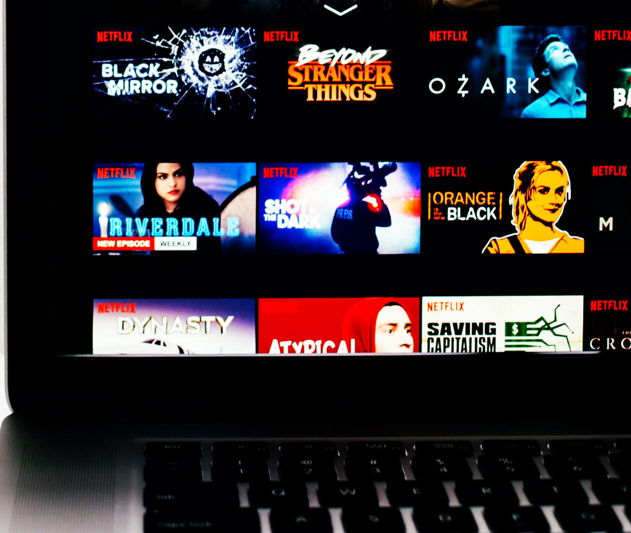 Close up of a laptop showing a variety of shows available to watch on Netflix