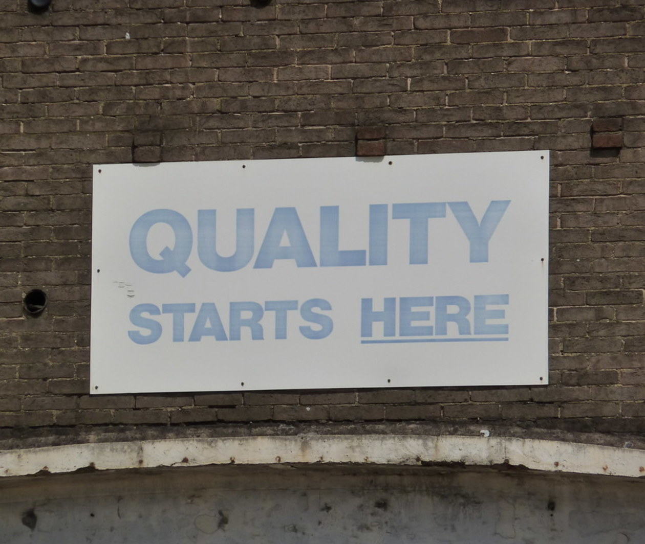 Sign reading 'quality starts here'.