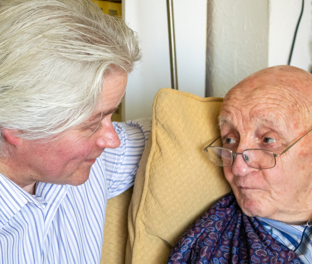 A Health Care professional discusses palliative care with an elderly patient