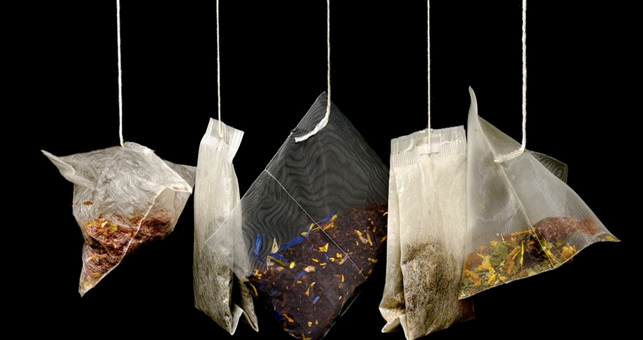 A row of a selection of teabags hanging down.