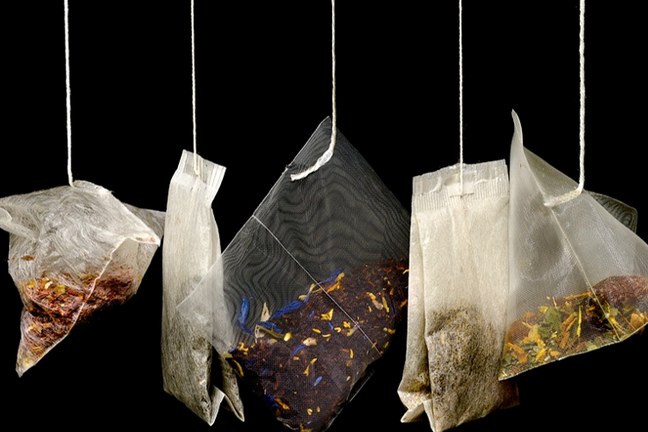 A row of a selection of teabags hanging down.