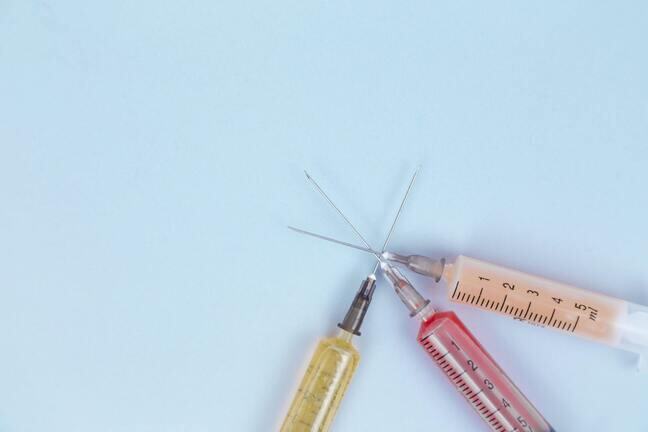 3 injection needles filled with yellow, red and orange liquids