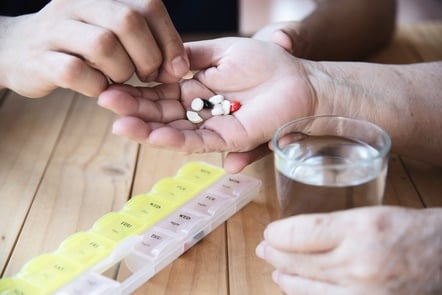 photo doctor is assist patient to eat medicine tablet in pillbox correctly