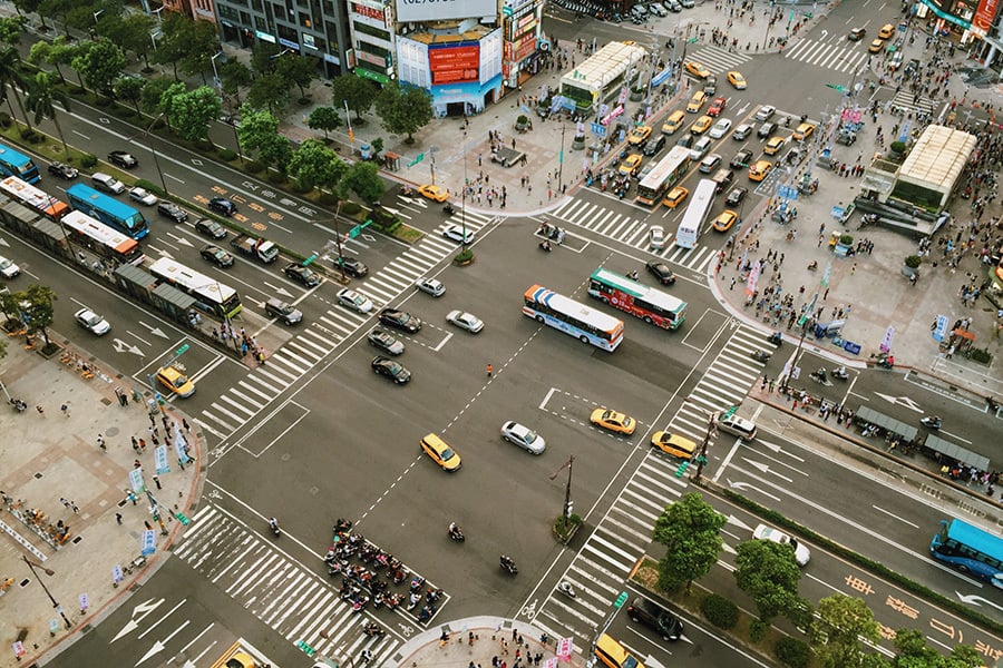 Birds eye view of city intersection busy with traffic