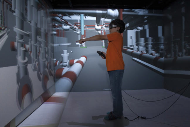 A boy wearing 3D glasses in 'The Cave'. Virtual reality.