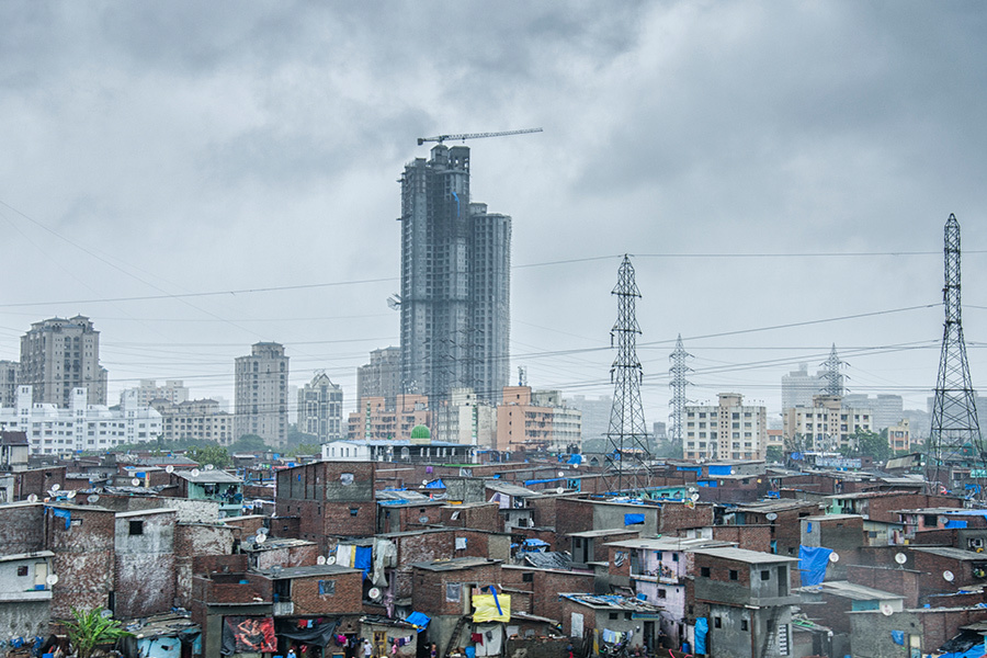 Mubai slums with skyscrapers in background.