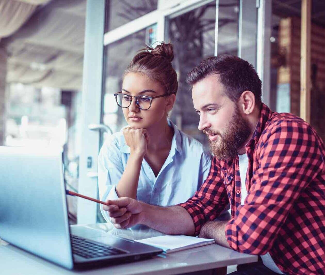 Men and women looking at a screen and debating 