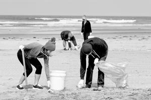 Young people litter-picking on a beach