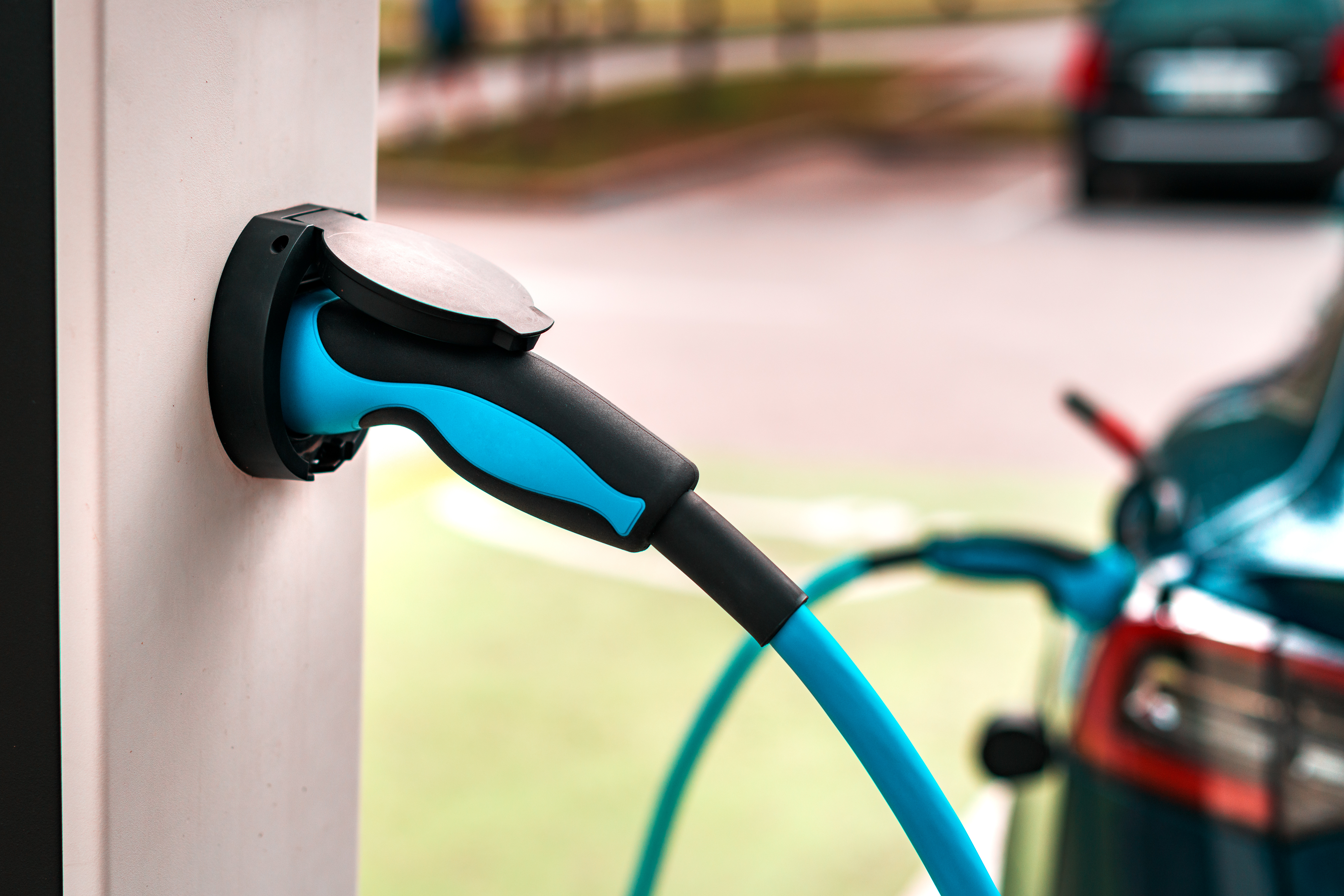 An electric charger plugged in to a car