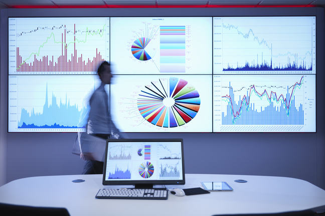 Data depicted on multiple screens in high tech room