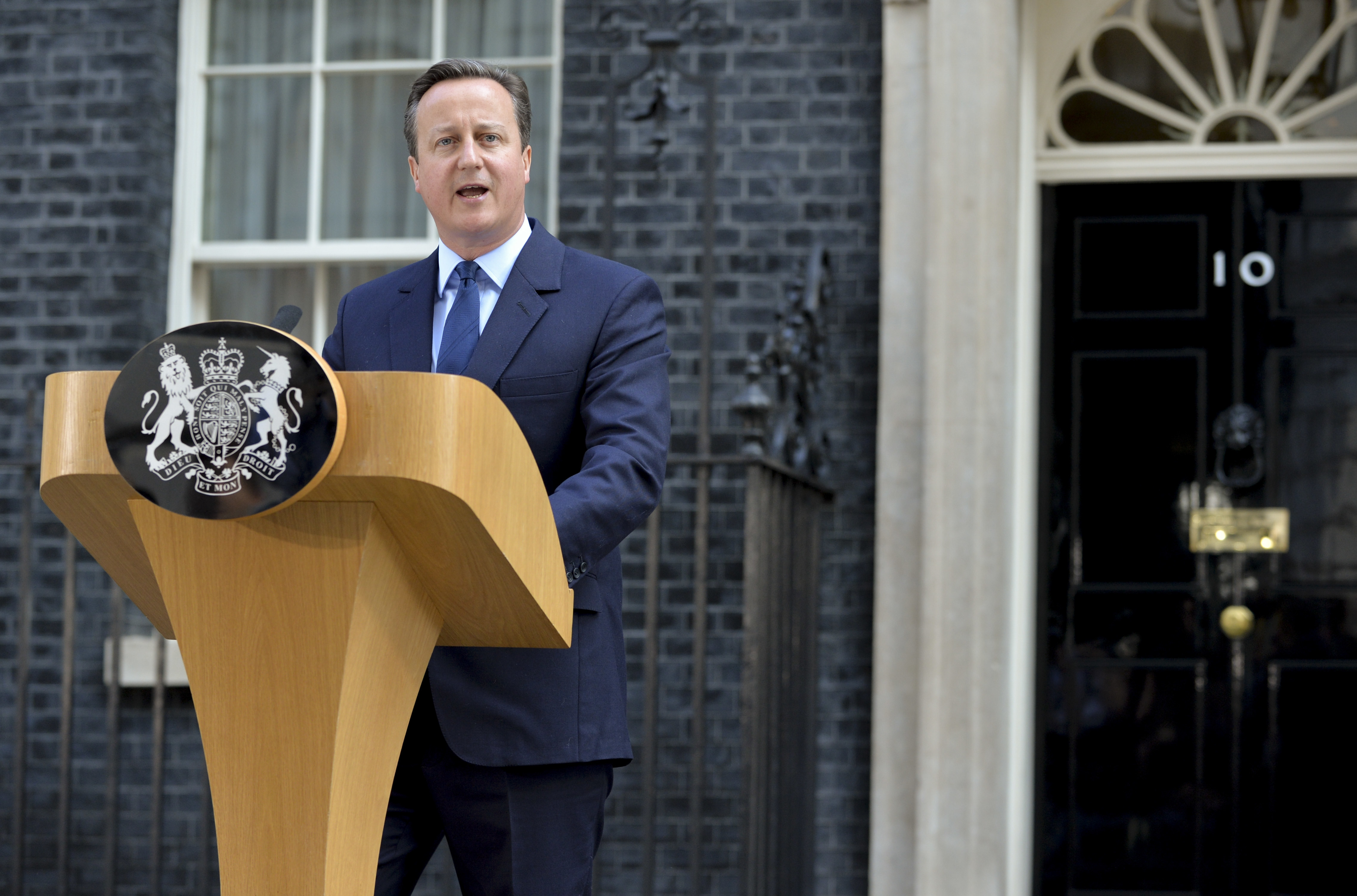 UK Prime Minister David Cameron standing at a podium in Downing Street giving a speech