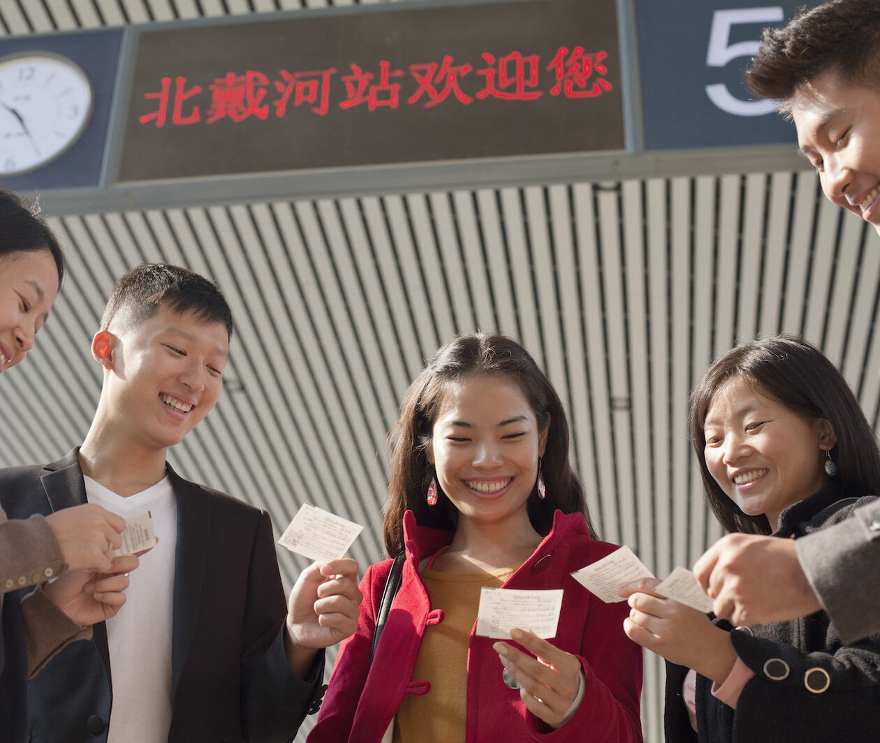 A group of people in front of a train station