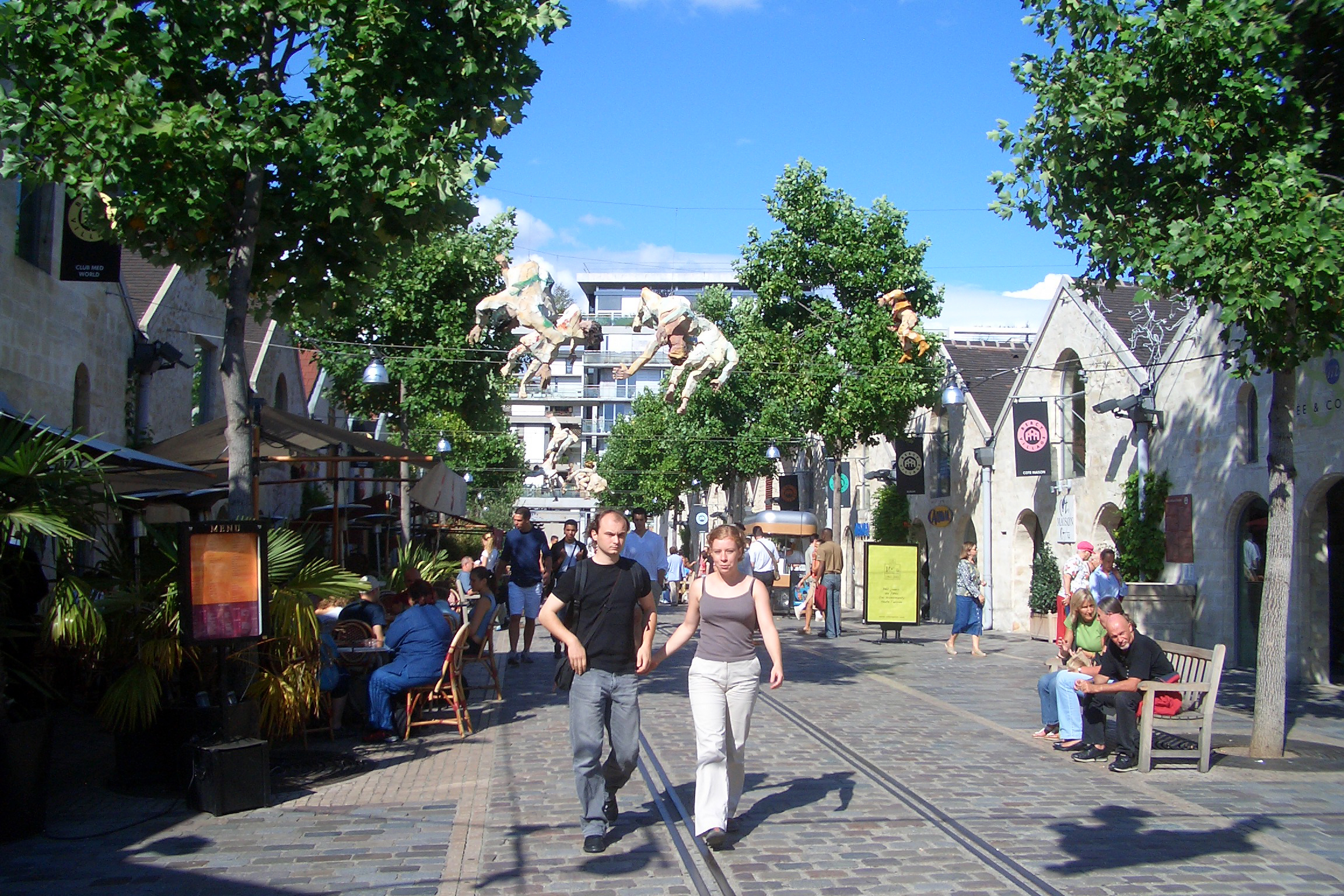 People walking along a street on a nice sunny day