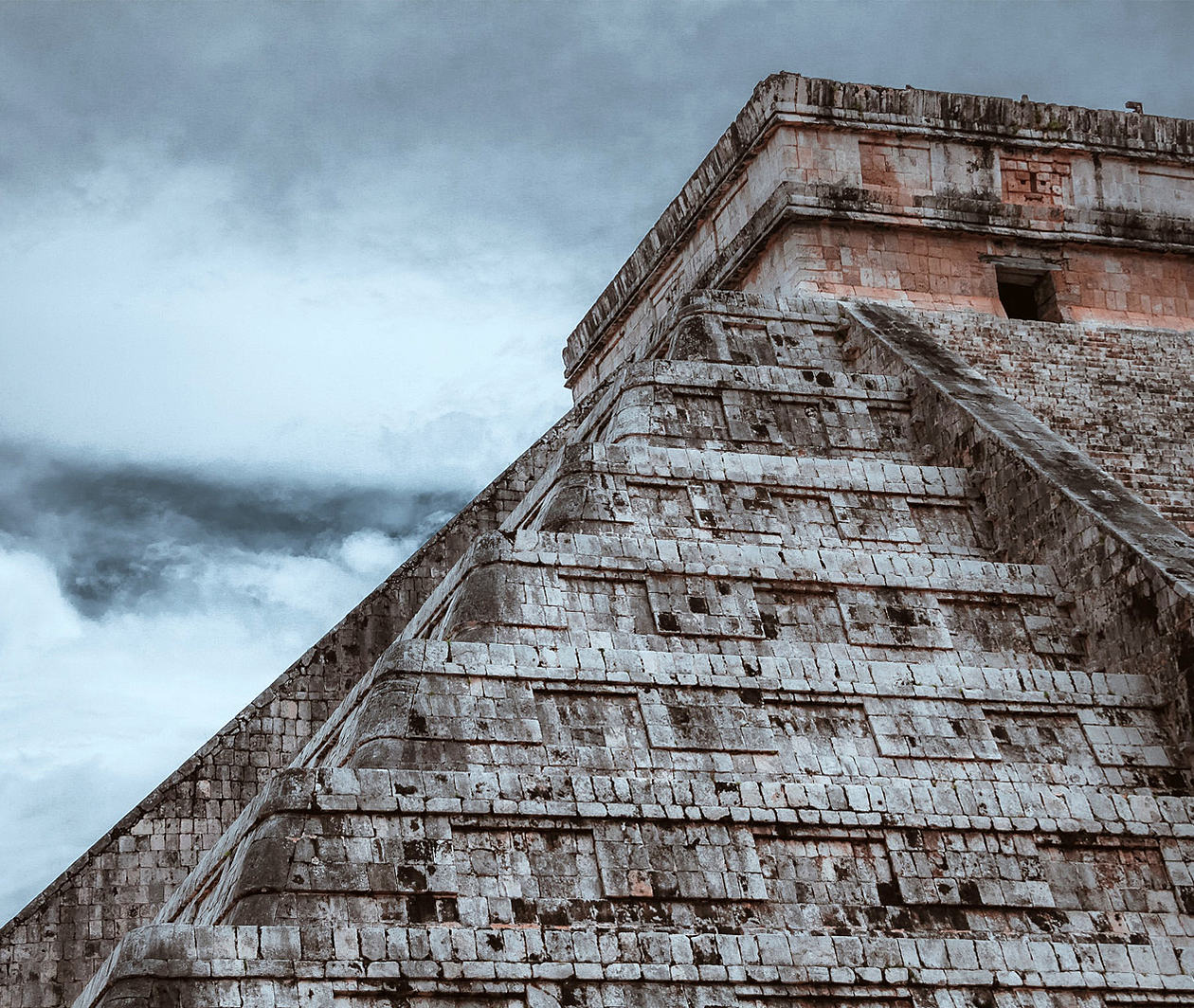 An ancient stone ruin against a stormy sky