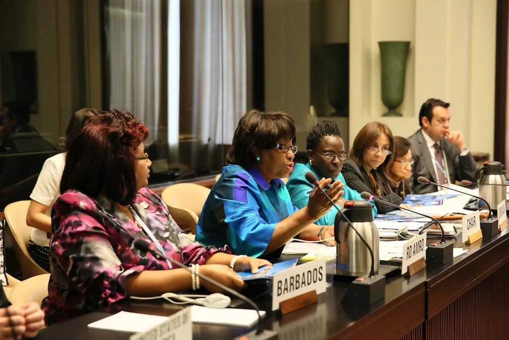 People are shown seated at a podium responding to questions from the audience