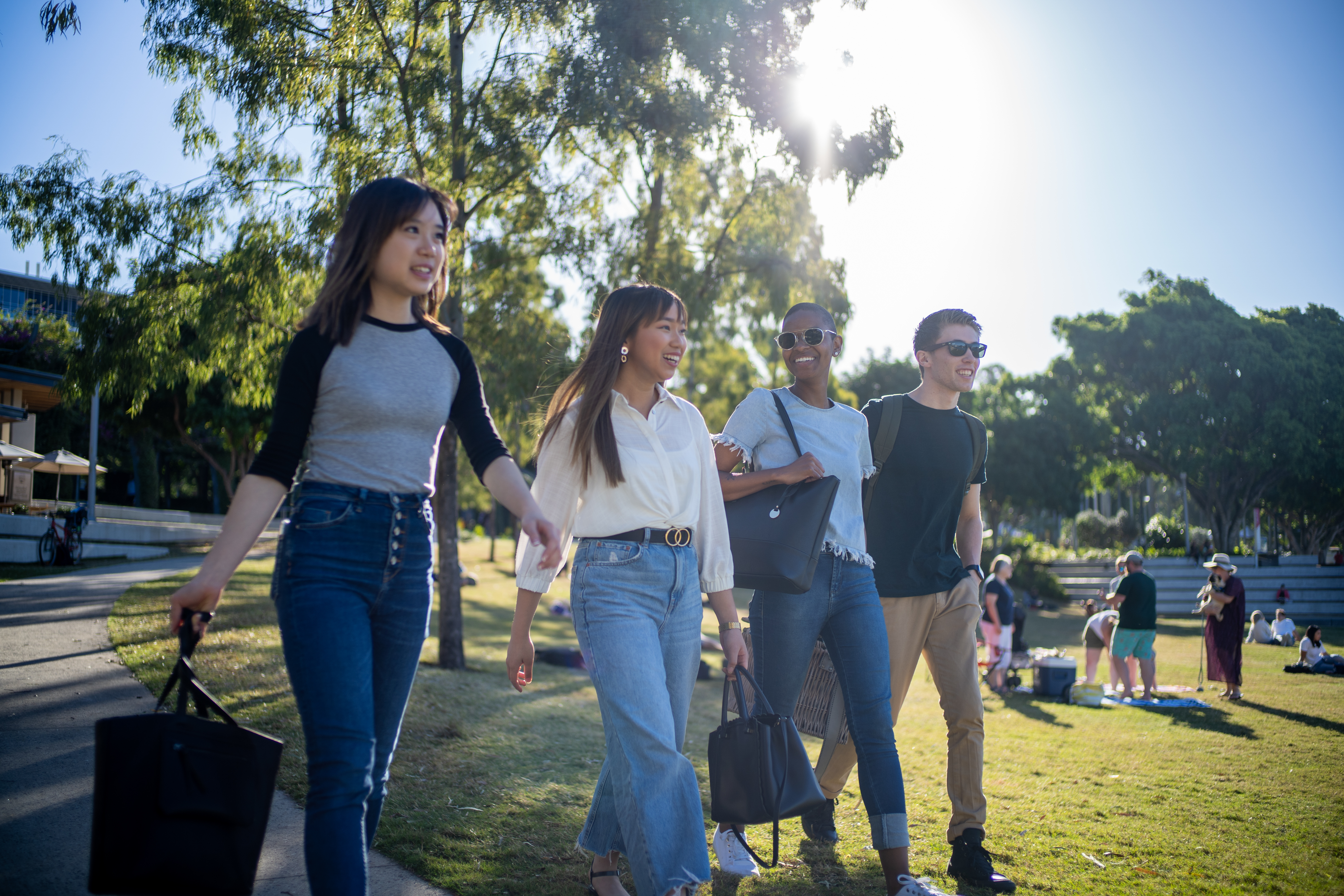 4 students walk in an Australian park