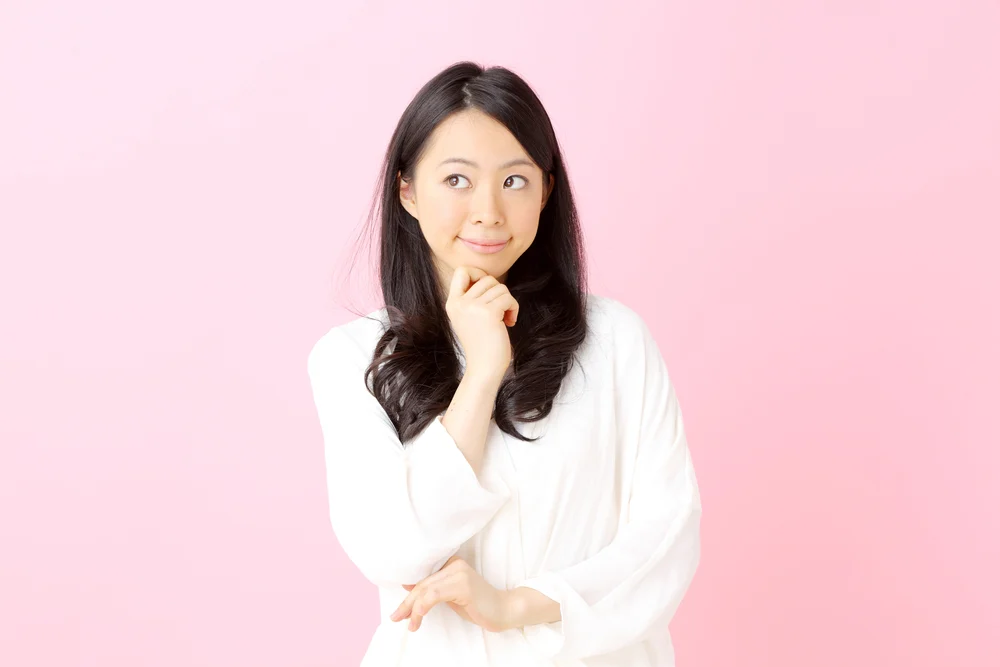 Woman standing with a pensive expression