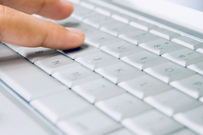 Person using computer keyboard.