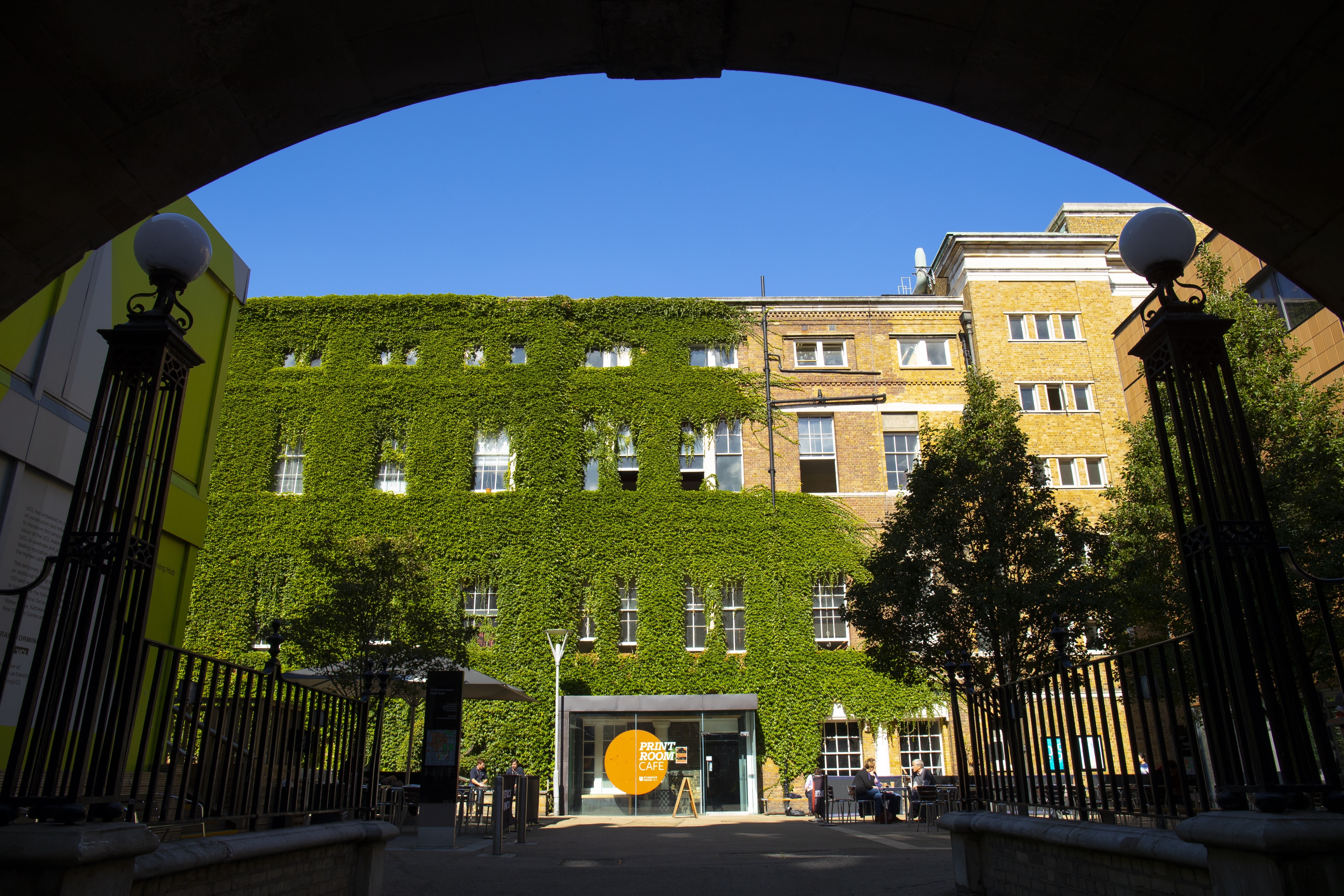Campus building at University College London An ivy-covered campus building at University College London, as seen through an arch.