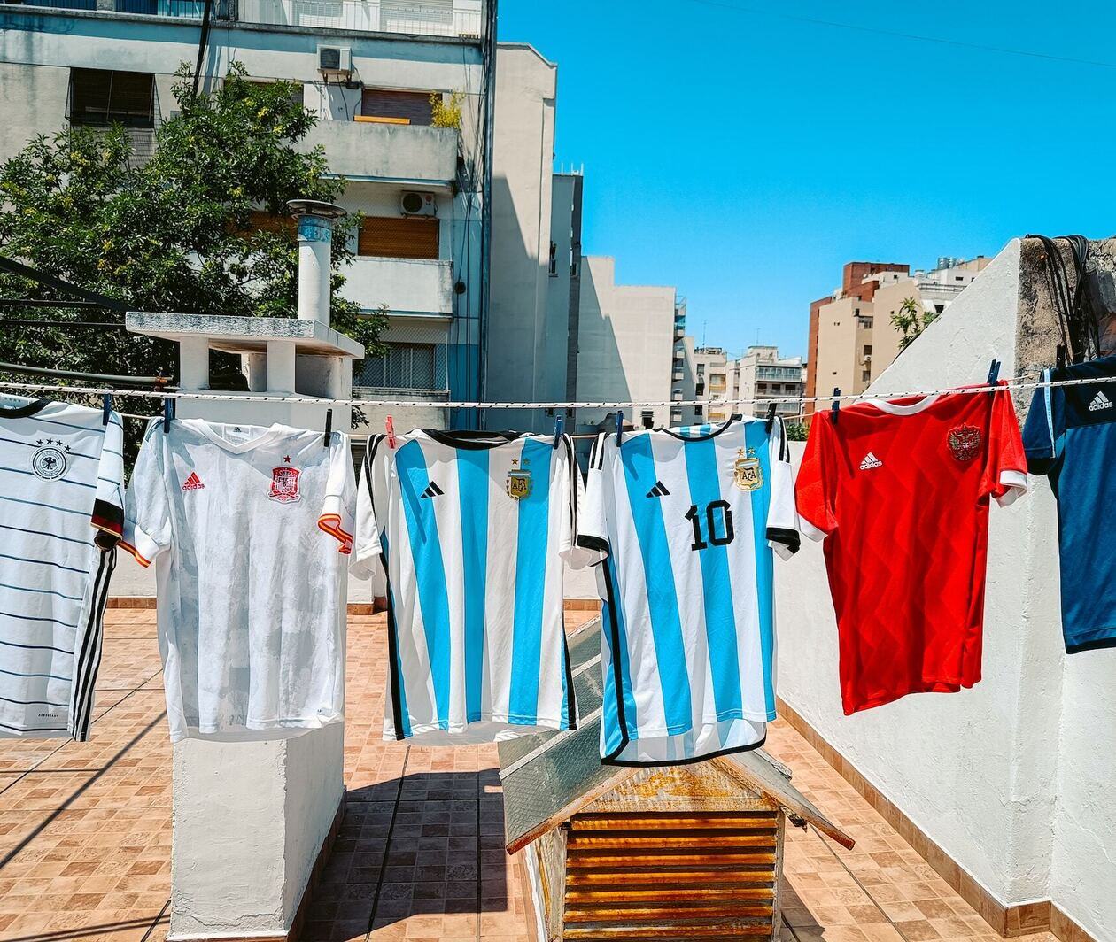 A selection of football shirts hanging on a washing line