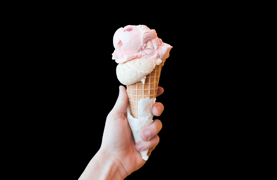 A hand holding an ice-cream cone