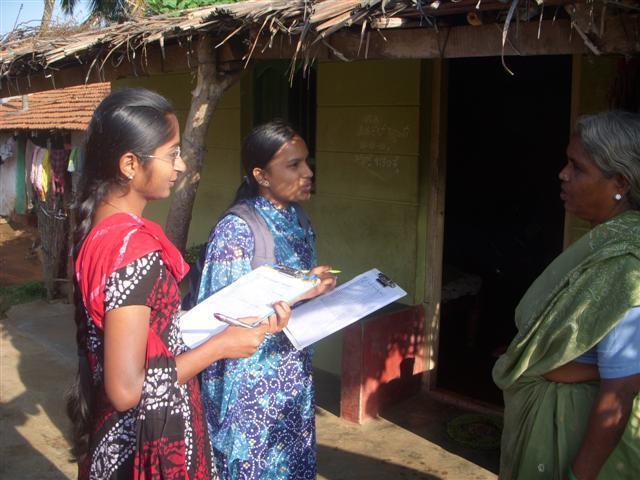 Image of two women conducting a survey at a medical camp.