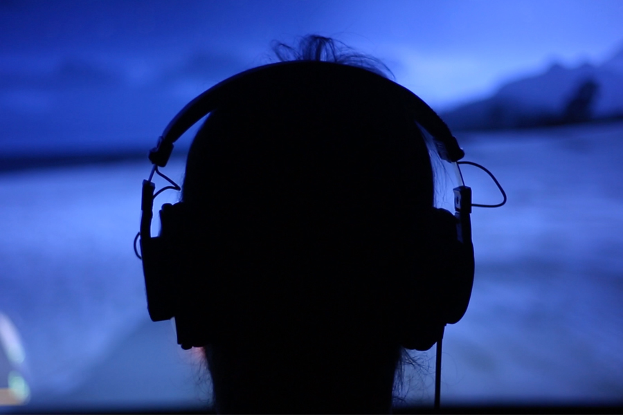 Sillhouette of person playing a game wearing a headset