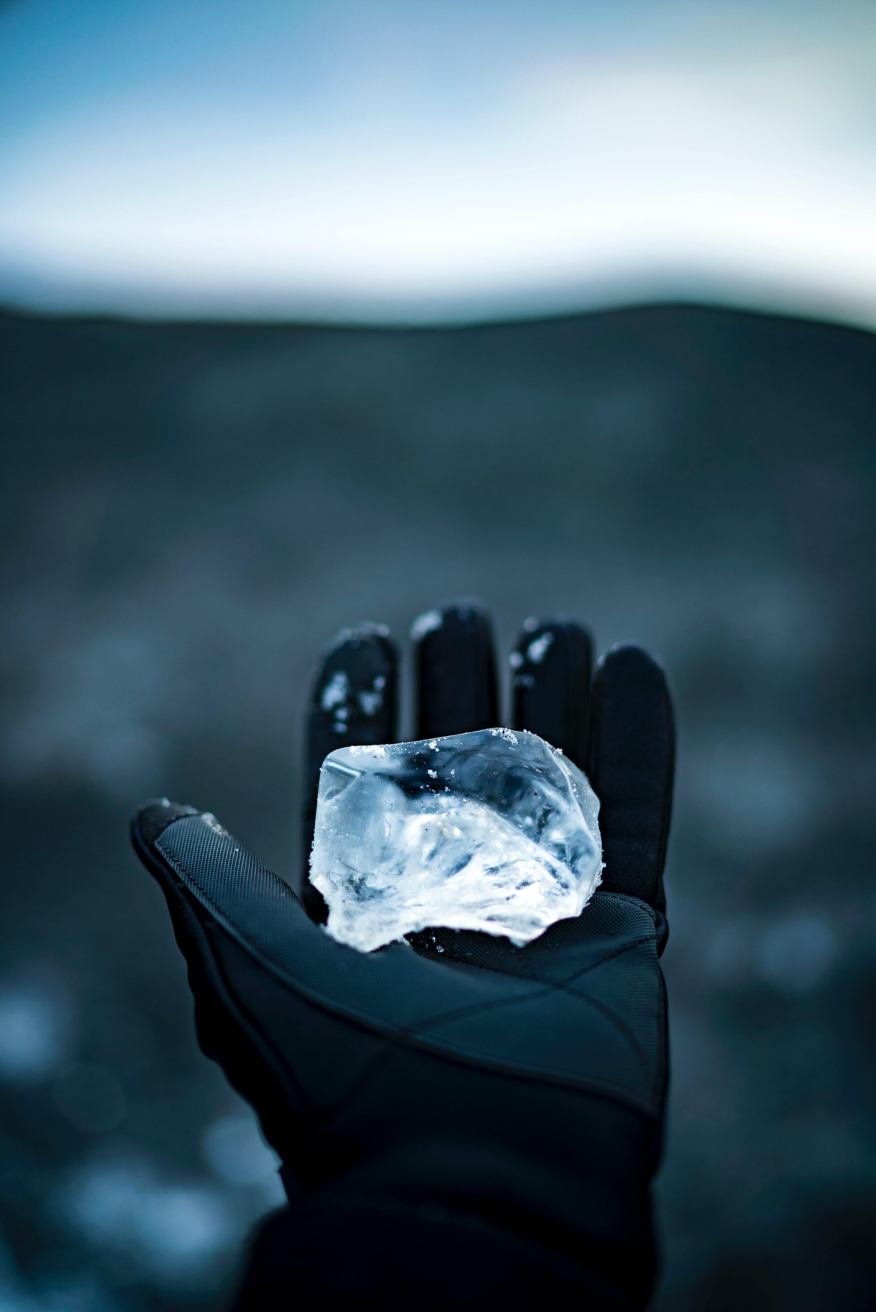 Ice held in a black glove