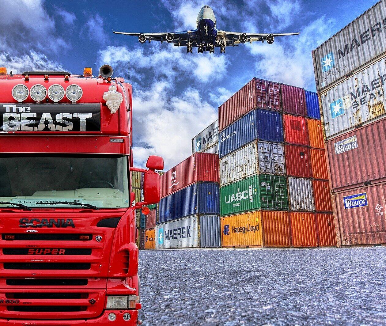Photo of a plane, lorry and shipping containers