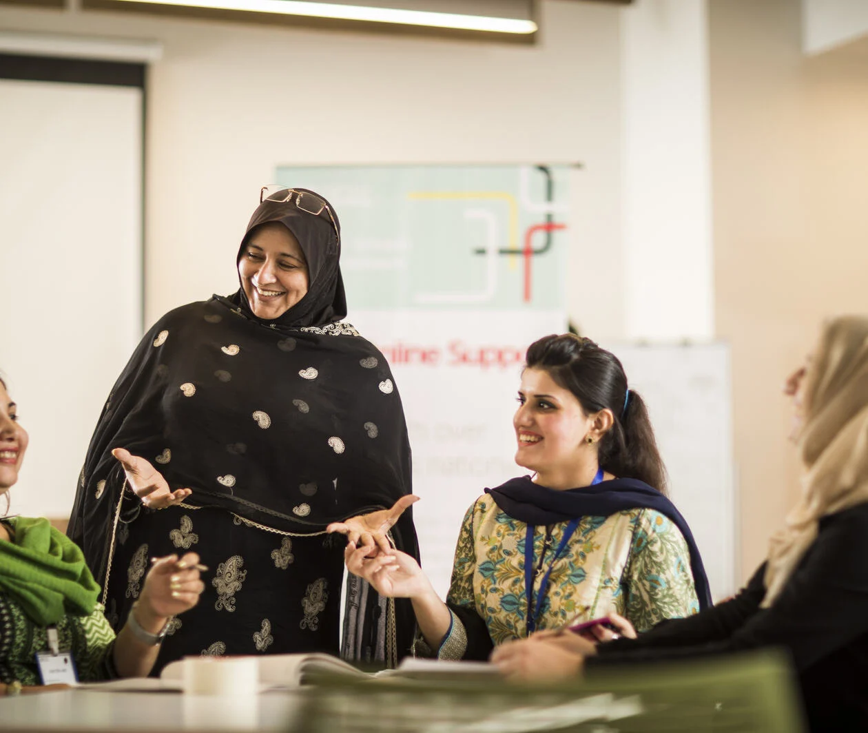 Group of women learning and teaching in classroom, developing their educational leadership and performance management